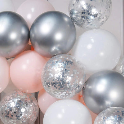 The Double Layered Pastel Pink, Silver and White Latex Balloon Garland Arch is composed of 60 pieces and is ideal for weddings, parties, and birthdays. The kit includes pink, white, and silver latex balloons, along with clear silver confetti balloons, allowing for a stunning balloon display. 