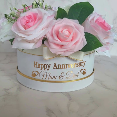 Nestled inside this delicately crafted handmade flower hat box lies a bouquet in shades of pink and white, a perfect gift for an anniversary celebration. The soft hues of the flowers exude elegance and charm, making it an ideal token of love and appreciation. This personalised creation conveys thoughtfulness and care, adding a special touch to the occasion