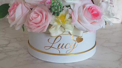 Elevate your gift with our Personalised Name Flower Hat Box, combining lifelike fabric, and soft foam pink and white roses. Adorned with the customised vinyl recipient's name, this bespoke arrangement is hand-crafted for maximum elegance. Perfect for birthdays, baby showers, weddings, anniversaries, or any special occasion, it's a gift that leaves a lasting impression. Order now for a memorable and personalised gifting experience! 🌸✨ Approx hat box sizes which are: 20cm